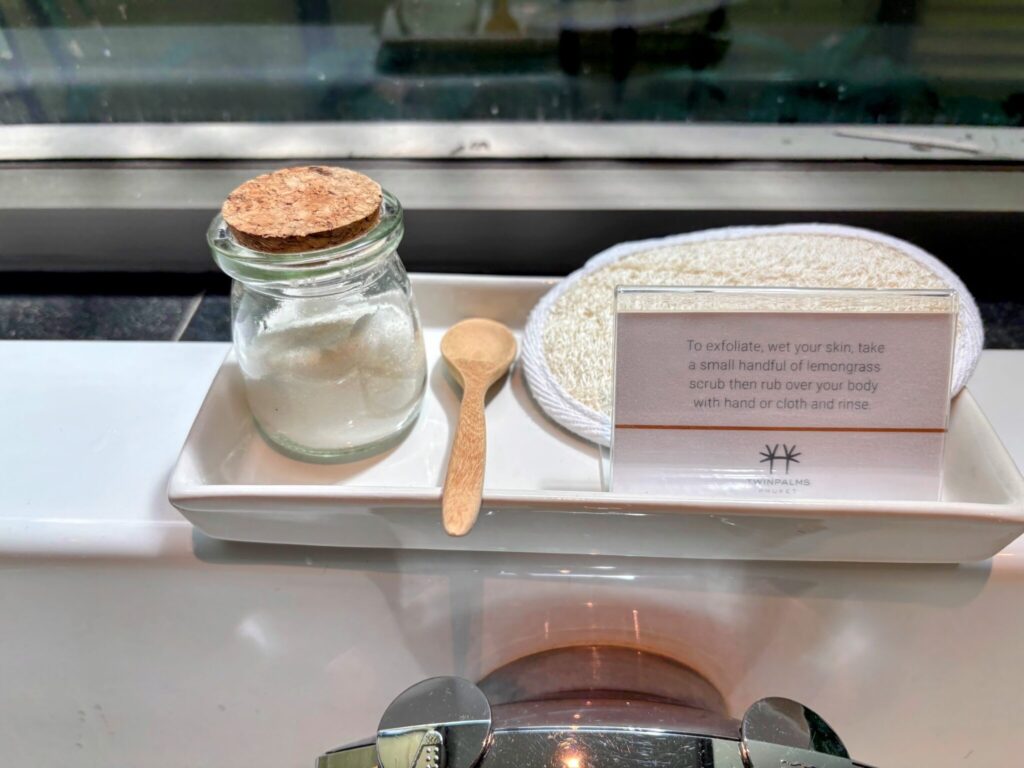 Bespoke lemongrass body scrub with wooden spoon and loofah pad in a Twinpalms Surin bathroom, Phuket