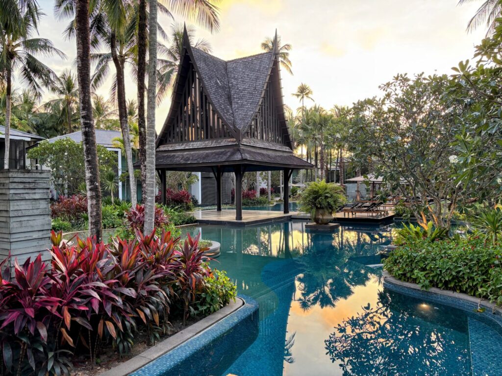 The lagoon pool and Thai sala pavilion at Twinpalms Surin, Phuket, surrounded by tropical planting at dusk